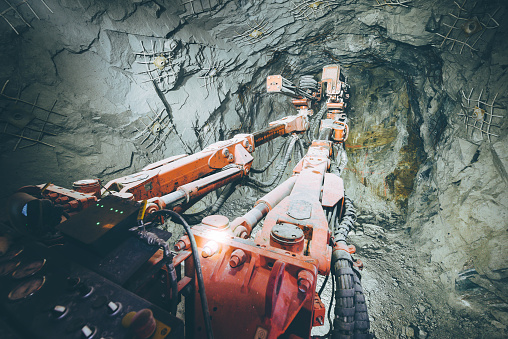 Gold mining deep underground, drilling the tunnel