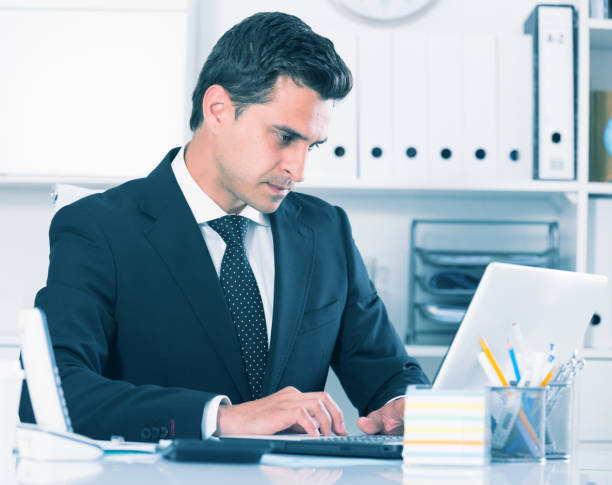 istock Serious businessman on laptop 809872676