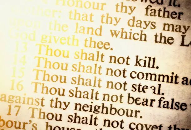 Close up on part of the Ten Commandments as seen in an old copy of the Holy Bible.