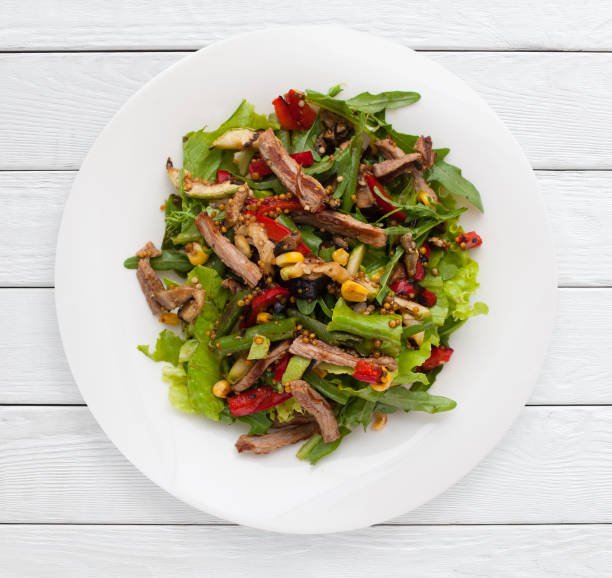 istock Multicolored vegetable salad with grilled meat 809877330