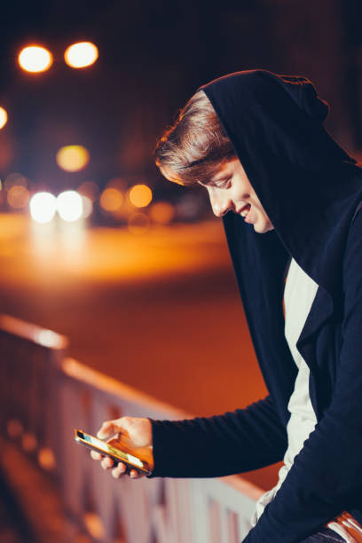 istock Handsome young man using smartphone in city 809878300