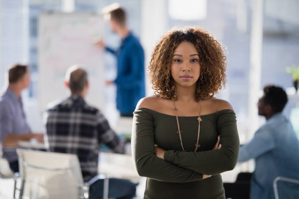 istock Female executive standing with arms crossed in the office 809887816