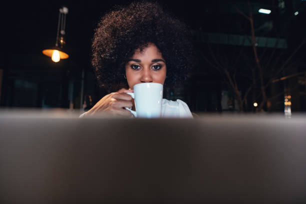istock Beautiful woman working late at night in office 809918040
