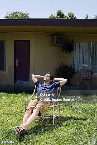 Man Sunbathing At Motel Stock Photo - Download Image Now - Chair, Yard - Grounds, Sunbathing