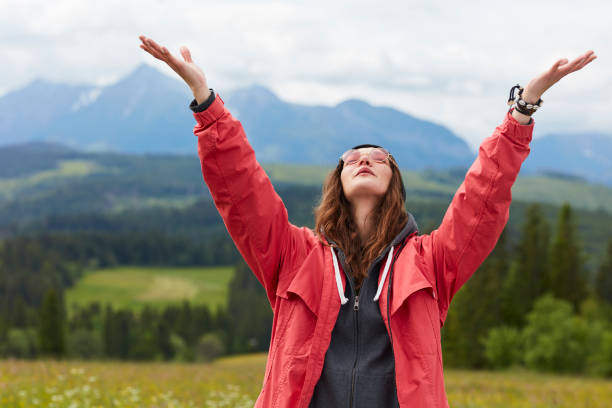 istock Young woman in the mountains. Embracing Nature 809924156