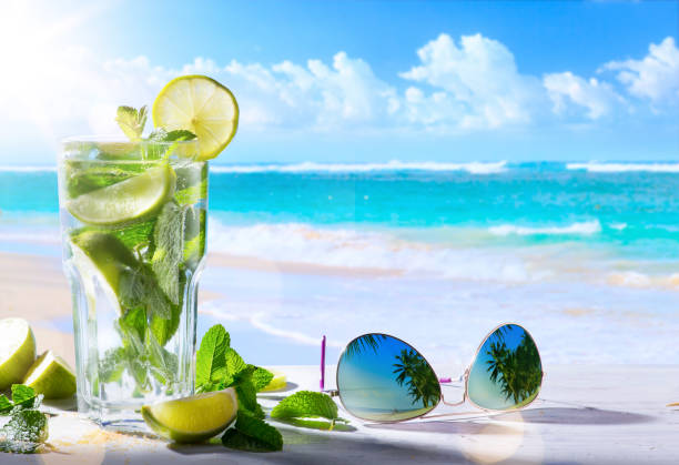 tropic summer vacation; Exotic drinks on blur tropical beach background tropic summer vacation; Exotic drinks on blur tropical beach background beach goa party stock pictures, royalty-free photos & images