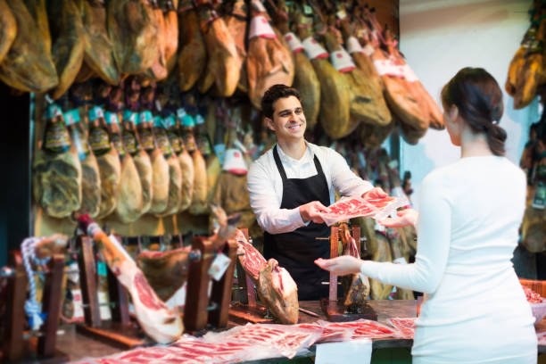 istock brunette choosing iberico and serrano jamon and smiling 809932742