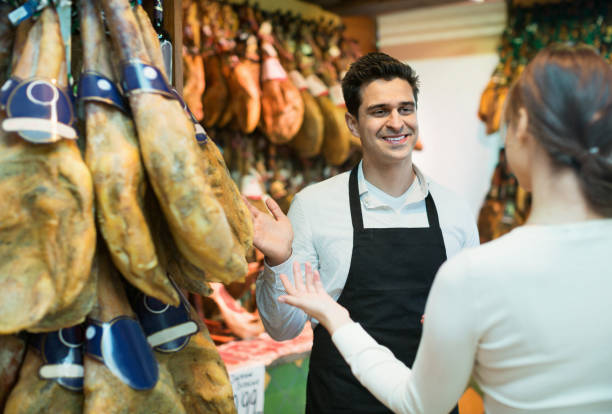 istock Young brunette choosing iberico and serrano jamon 809932784