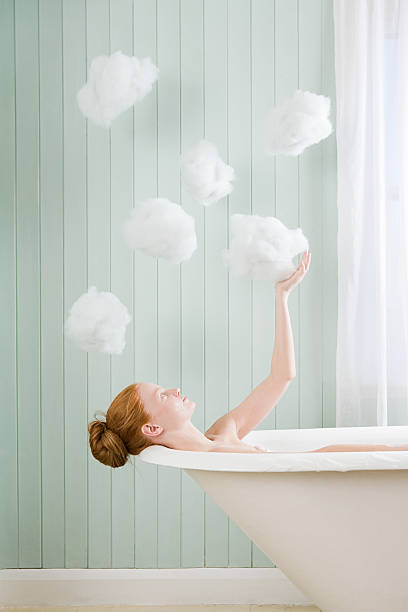 A woman touching a cloud  cotton cloud stock pictures, royalty-free photos & images