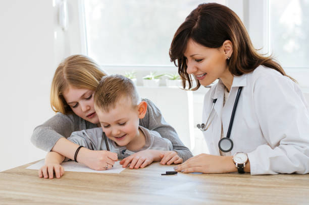 istock Female doctor playing with kids in office 809940072