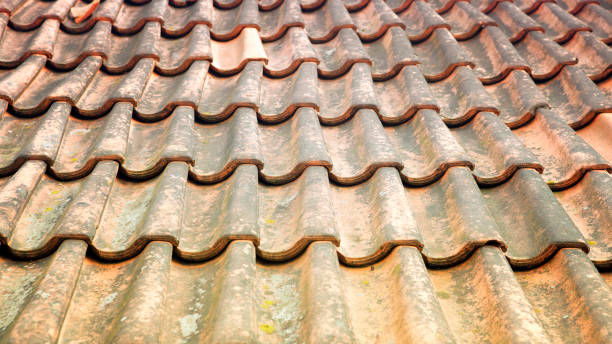istock old weathered roof with red tiles 809943040