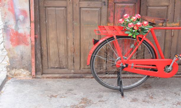 istock flower on saddle red bicycle classic vintage on wall wood background 809943666