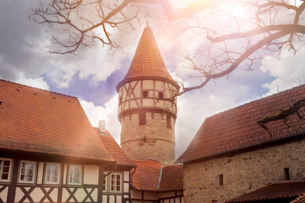 closeup of old medieval tower and houses with red roofs
