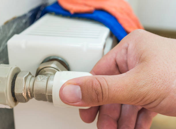 istock Person adjusting thermostat control on a central heating. Temperature control valve on a radiator. 809947160
