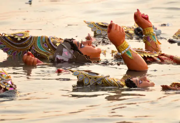 Immersion of goddess durga idol in river after completion of festival