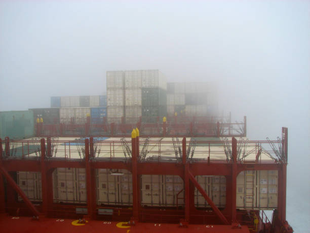 istock Large container vessel in ocean view from captain's bridge, pilot bridge in very strong fog. Large vessel in foggy weather in ocean. There are no logos in photo 809948162