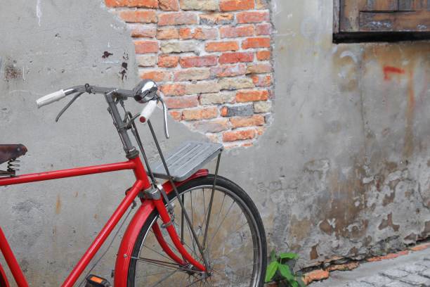 istock Vintage Red bicycle near the old wall home background 809954542