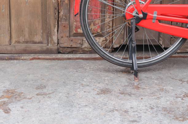 istock Vintage Red bicycle near the old wall home background 809954556