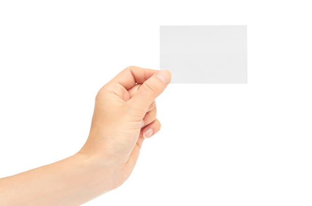 istock Female hands hold a business card. Isolated on white background 809954692