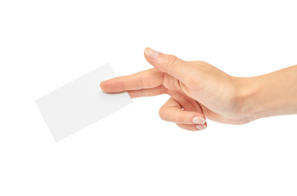 istock Female hands hold a business card. Isolated on white background 809954710