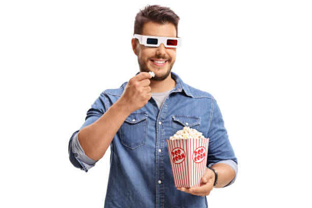 istock Man wearing a pair of 3D glasses and eating popcorn 809958862
