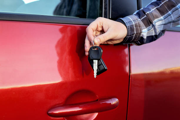 istock Red car and man's hand with car keys 809979662
