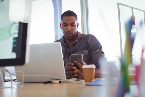 istock Young businessman using mobile phone in office 809982360