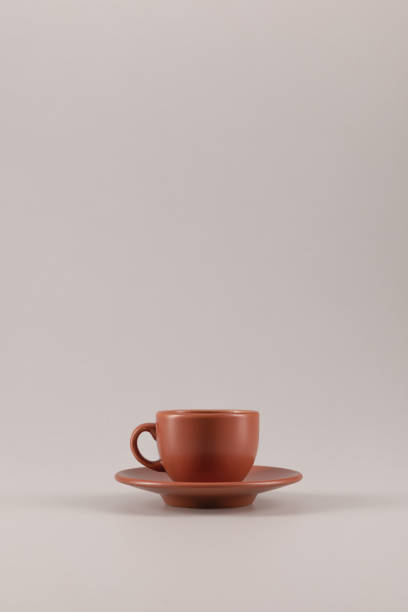 istock one ceramic coffee cup on saucer isolated on beige with copy space 809982914