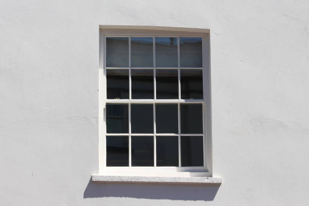 istock An old sash window, central, with grey paintwork to external of building 809985502