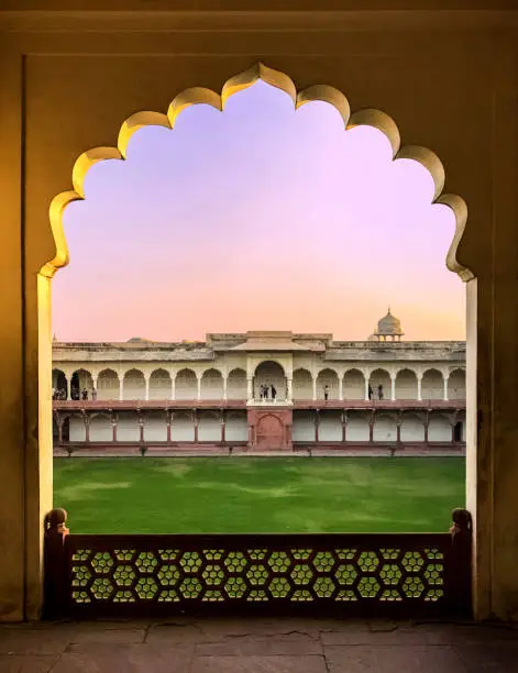 A beautiful large window view at the Agra Fort during the sunset.