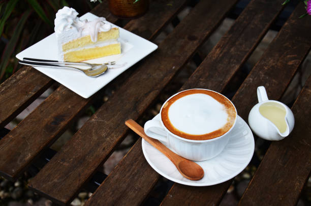 istock Latte Hot Coffee and Coconut Cake on table 809986278