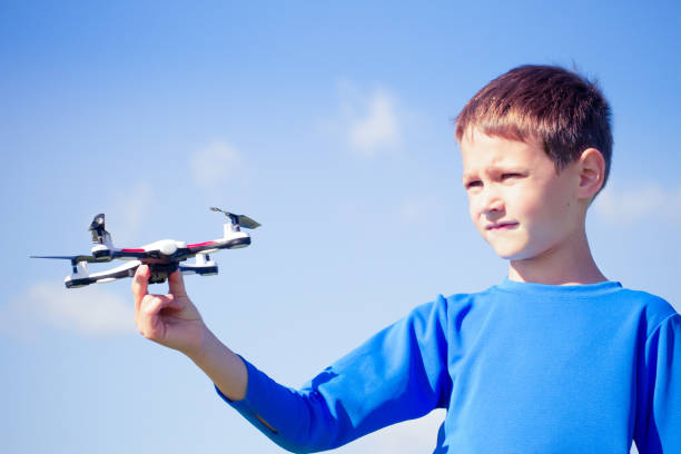 istock Boy playing with drone outdoors. 809986324