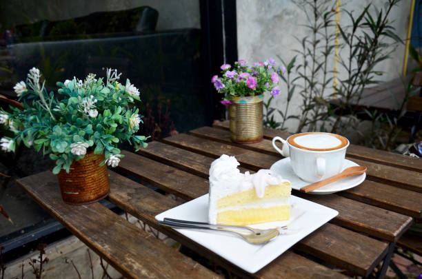 istock Latte Hot Coffee and Coconut Cake on table 809986628