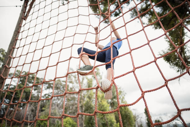 istock Woman climbing a net during obstacle course 809992062