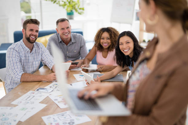 istock Team of executives using electronic devices in the office 810005510