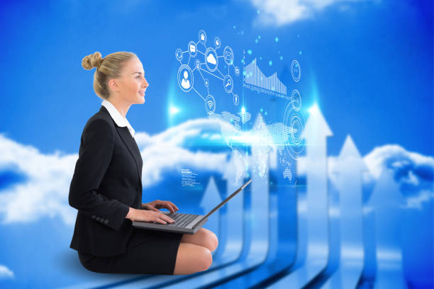 istock Blonde businesswoman sitting using laptop with interface 810011446