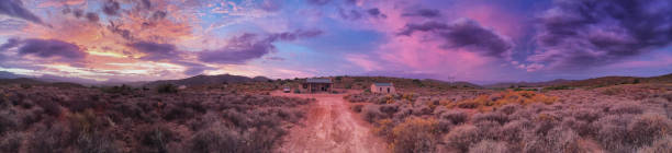 A spectacular Sunset panoramic image of a farmstead with car and pink blue purple sky sunset McGregor Little Karoo Boland Western Cape South Africa