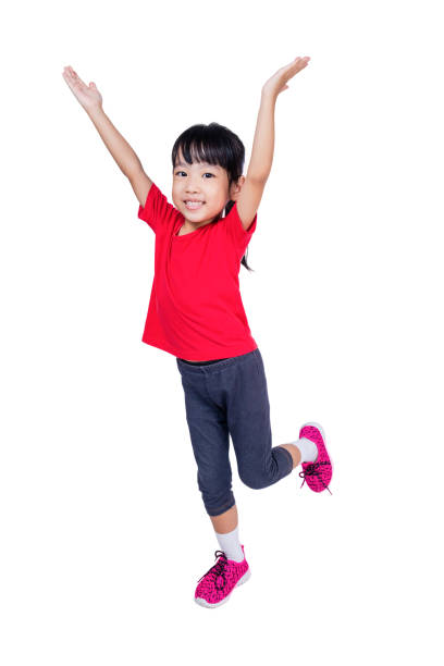 asian chinese little girl jumping up and wave her hands - gymnastics smiling little girls only isolated on white imagens e fotografias de stock