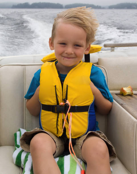istock Happy boy riding in a motor boat in the wind 810030998