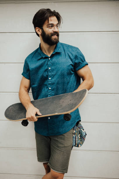 istock Beautiful young man holding a skateboard 810038390