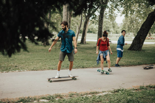 istock Friends are skateboarding at public park 810047374