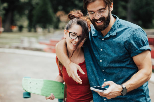 istock A lovely couple is having fun at the skatepark 810047514