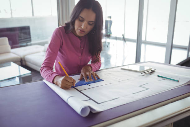 istock Female interior making diagrams on paper in office 810057698