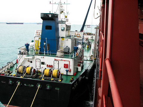 Bunkering tanker container ship in port close up