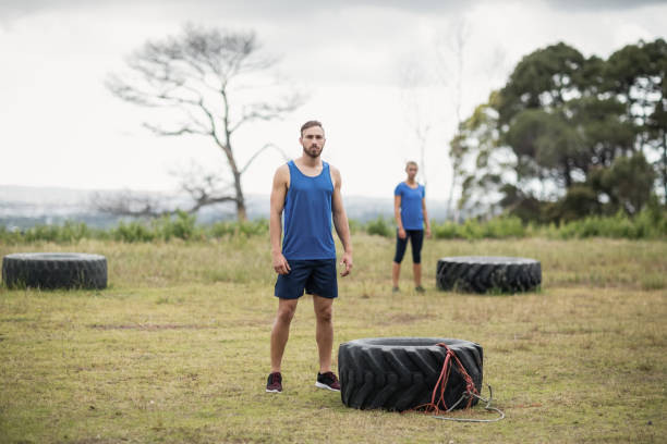 istock Fit woman standing near tyre during obstacle course 810071118