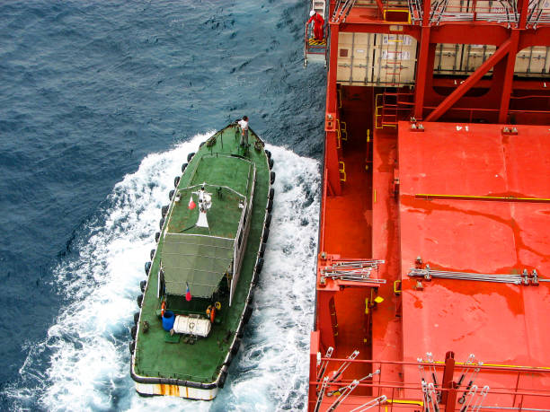 istock pilot vessel is moored to side of merchant ship 810071912