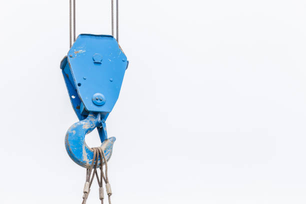The old blue lifting crane hook is used in construction site on white background.