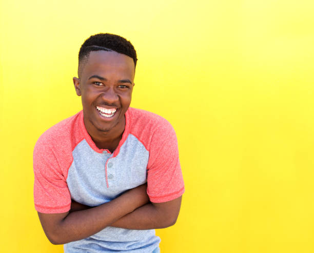 istock happy young african american man laughing against yellow background 810099788