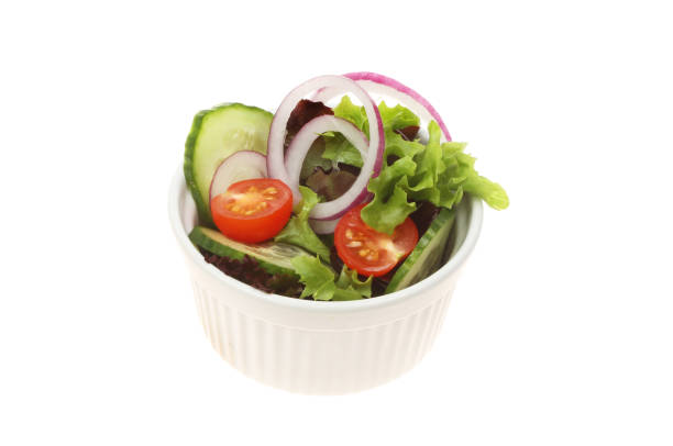 Salad in a ramekin Fresh salad in a ramekin isolated against white side salad stock pictures, royalty-free photos & images