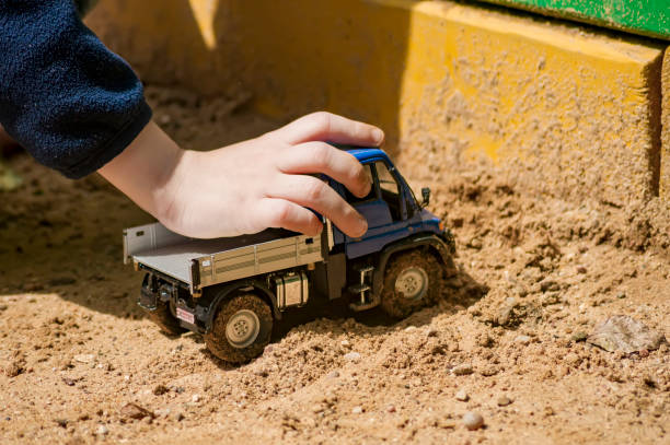 istock A boy is playing in a truck in a sandbox 810105438
